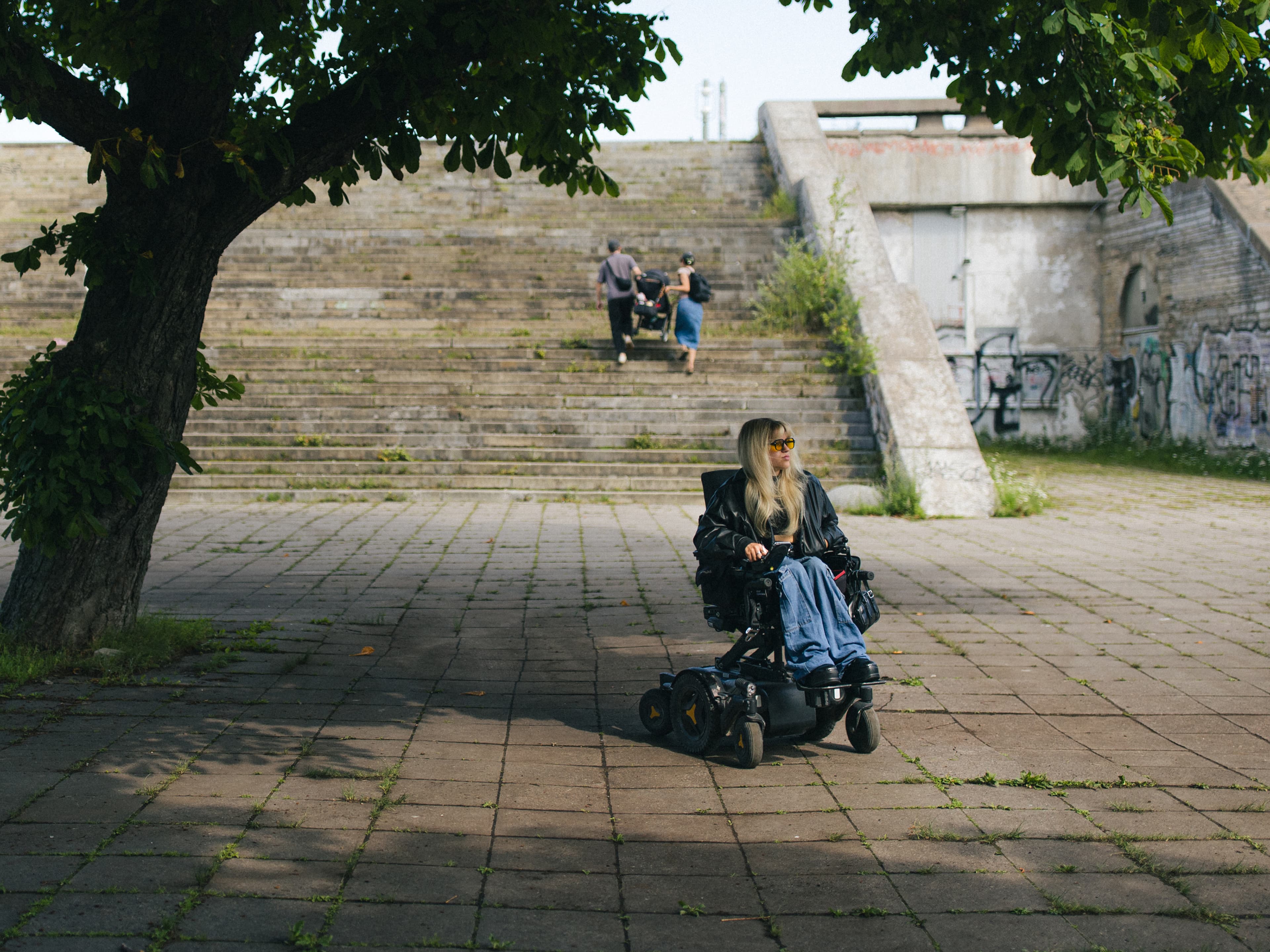 Powerchair user at outdoor stairs without ramp access