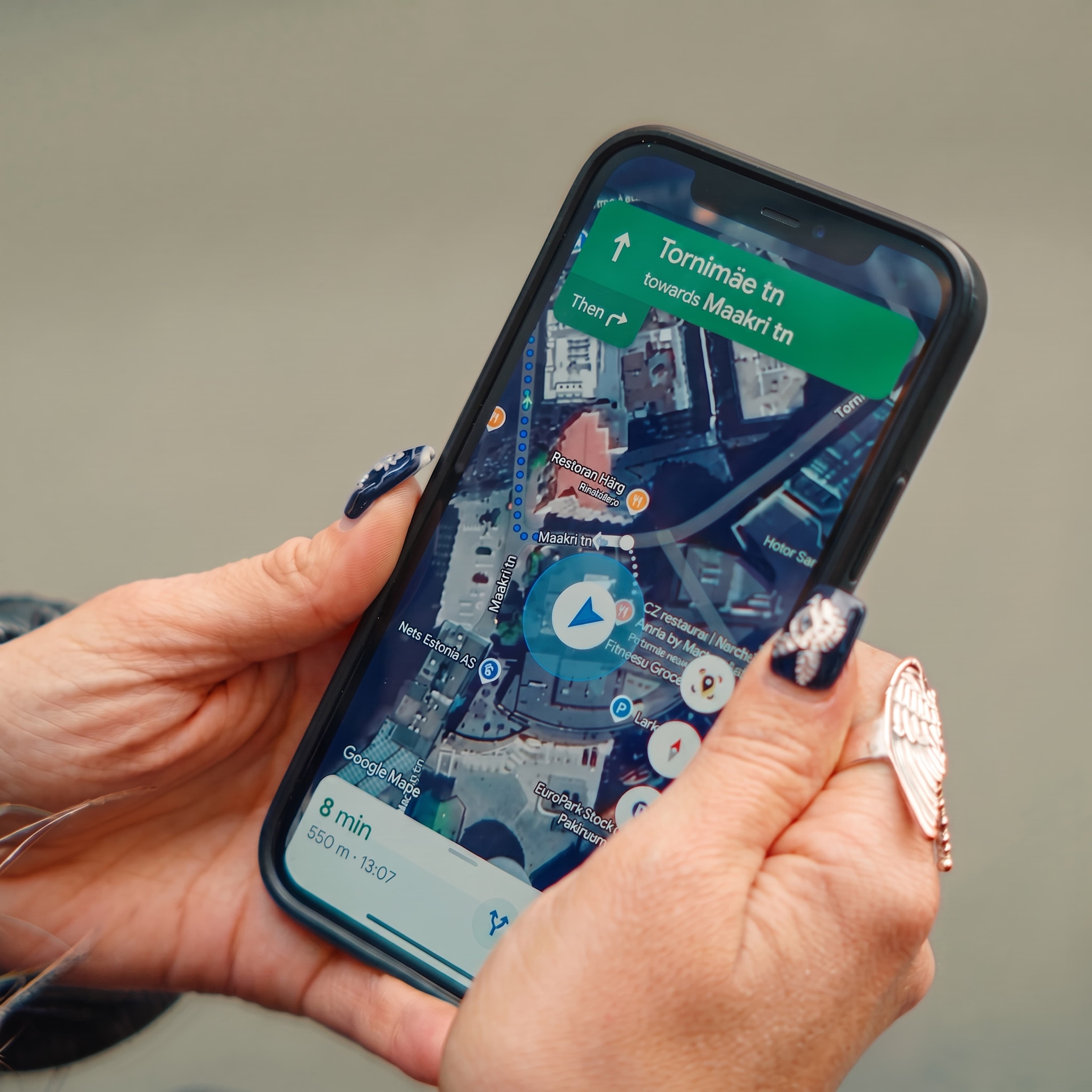 Hands holding a phone showing Tallinn navigation