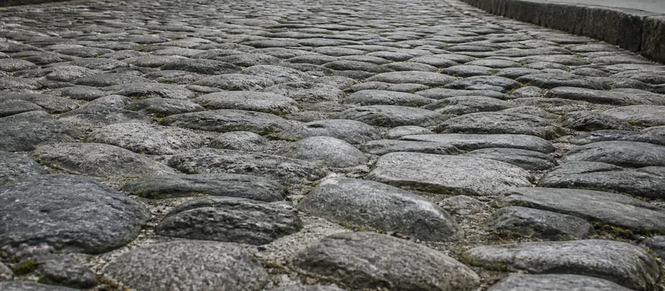 Illustrative close view of rough, uneven historic cobblestones