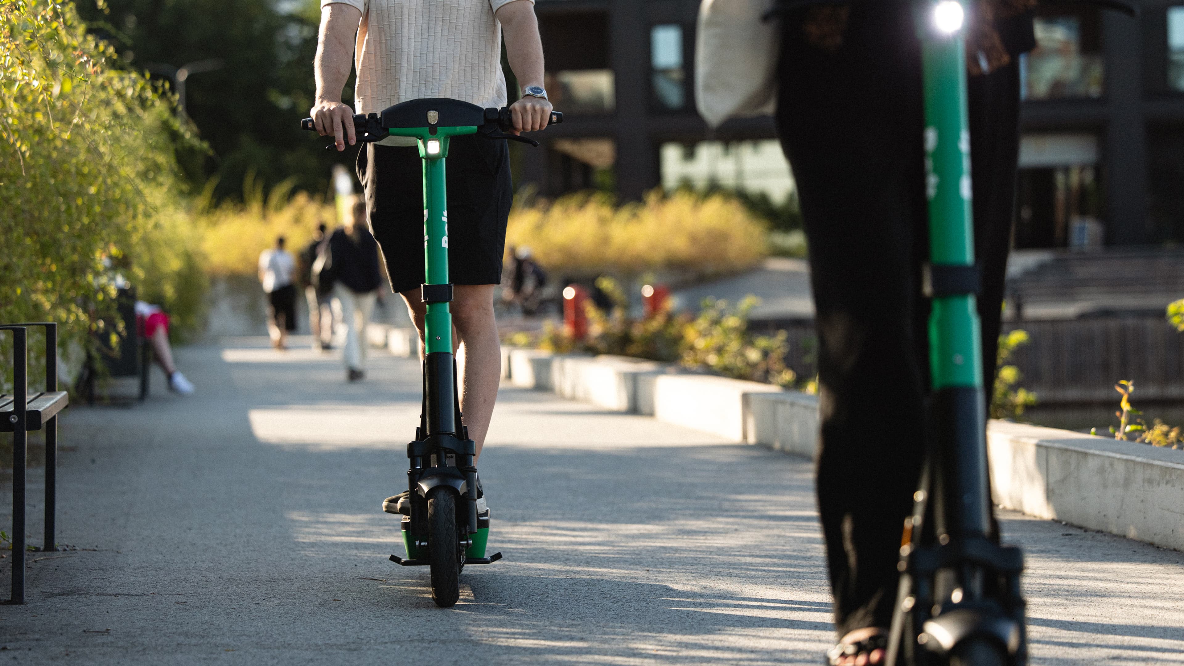 Bolt scooter riders on a promenade