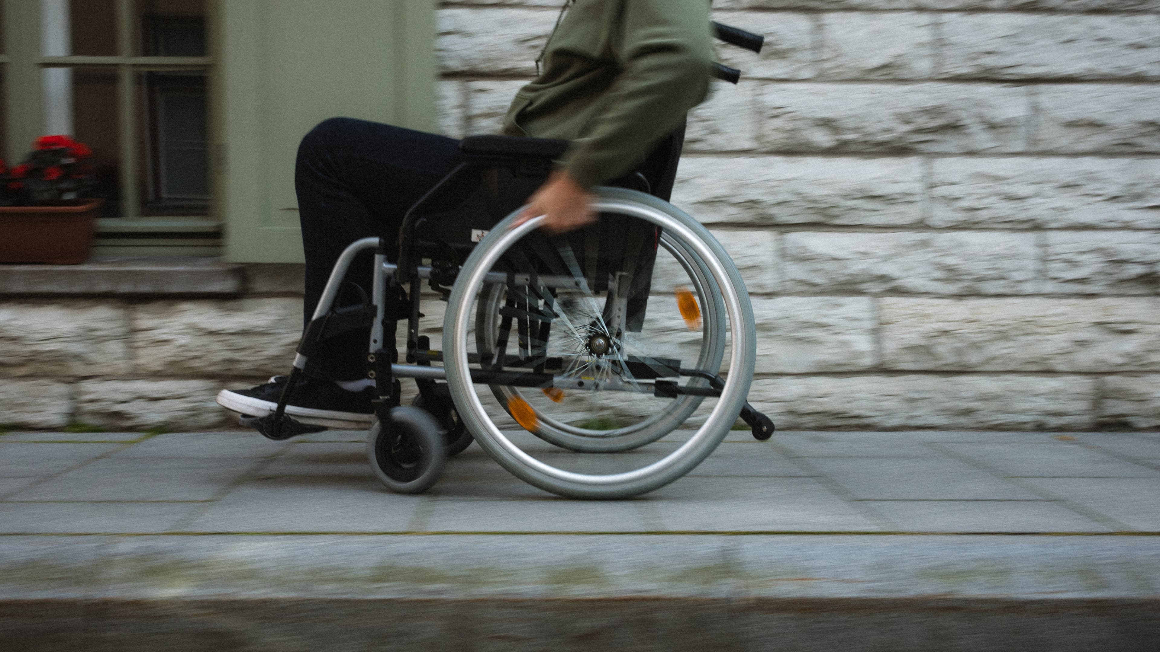 Wheelchair user moving along a city sidewalk